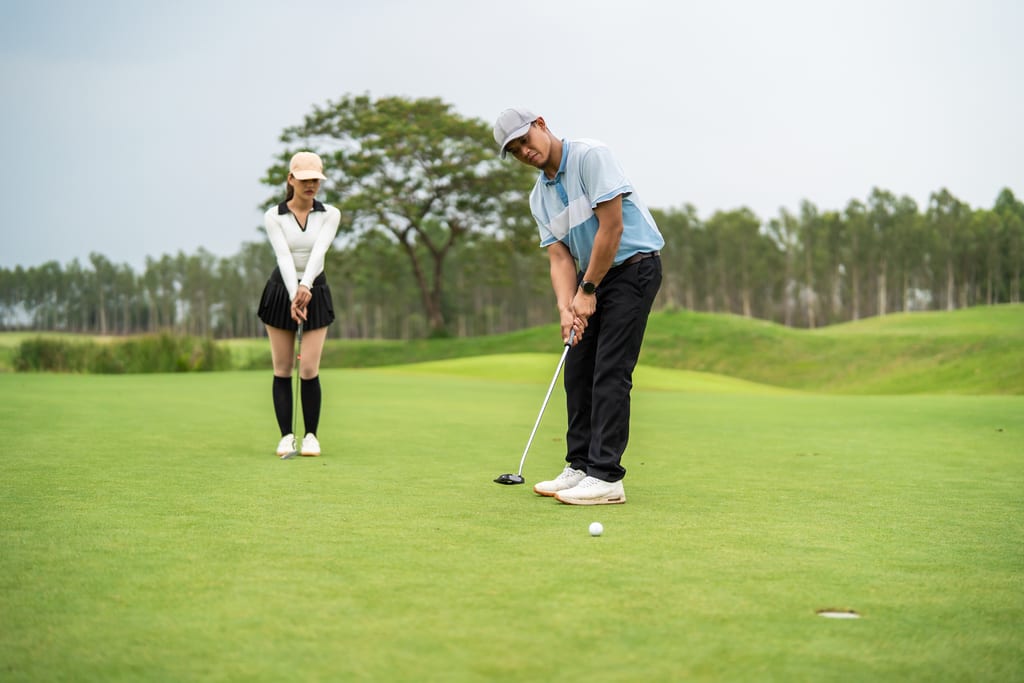 A golfer preparing a putt while a companion watches on the green