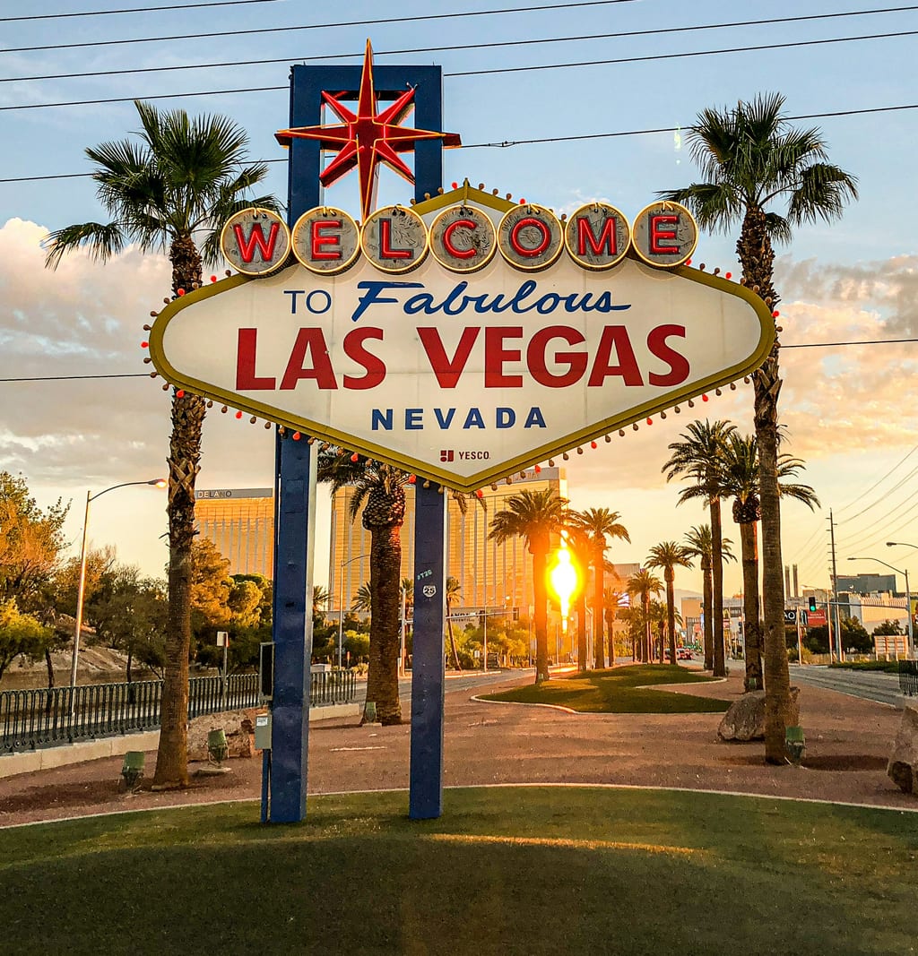 The “Welcome to Fabulous Las Vegas” sign at sunset, between palm trees