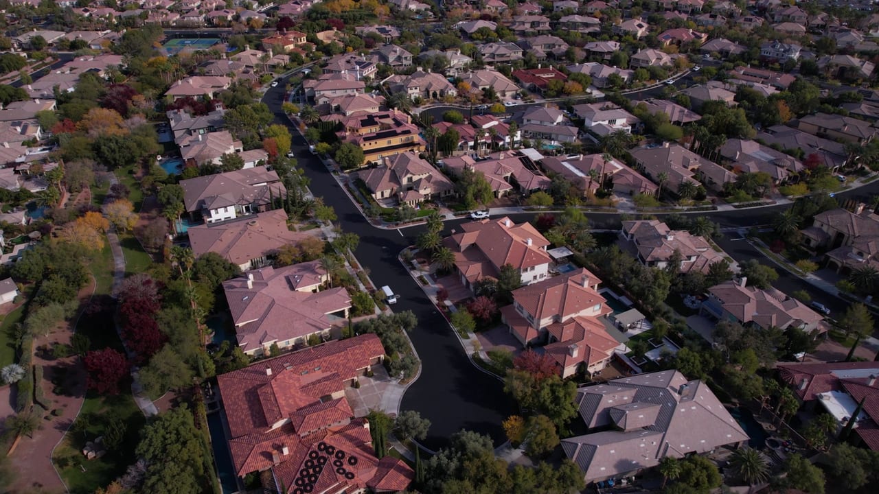 Summerlin homes seen from above, with tree-lined streets, pools and a walking path