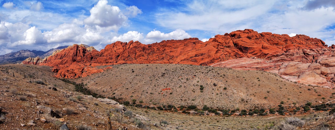 Red sandstone formations beneath a blue sky at Red Rock Canyon, Nevada.