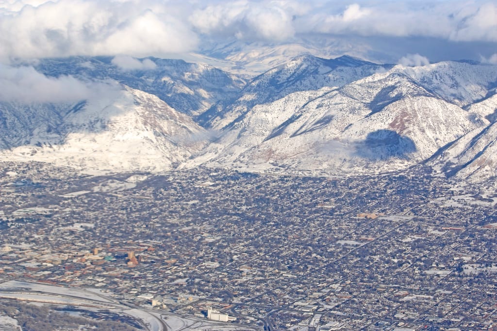 Snow-covered Wasatch mountains above neighborhoods in northern Utah.